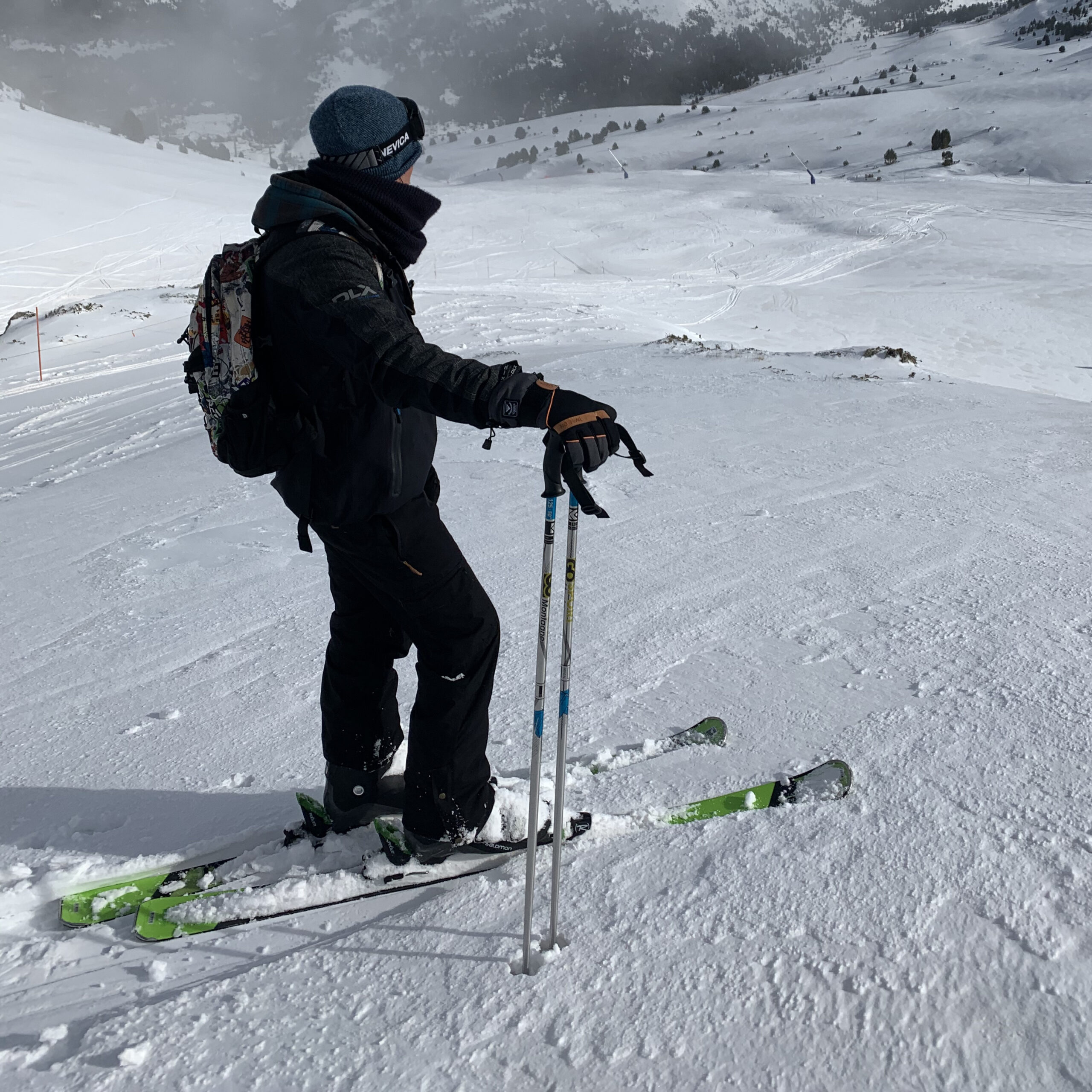 Skiier in front of a pist down the hill.